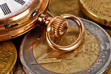 Euro coins and pocket watch