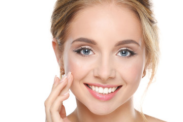 Young woman touching her face isolated on white background