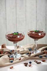 Chocolate mousse with fresh berries on wooden background