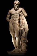 Fototapeta na wymiar A statue of powerful Hercules, closeup, isolated in black