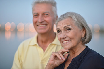 Happy senior couple  near river