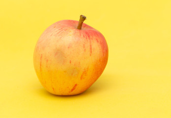 ripe apple on a yellow background