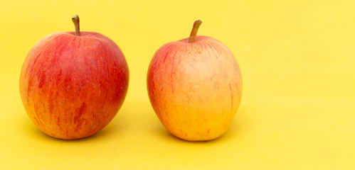 ripe apples on a yellow background