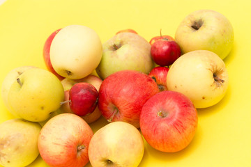 ripe apples on a yellow background