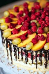 Fruit, cake naked. homemade cake with raspberries, grapes, and p