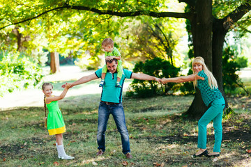 Obraz premium Happy family in the park. Happiness.