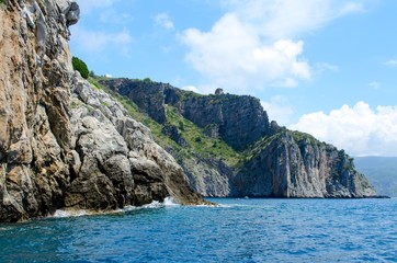 Watchtower on a marine cliff over sea in blue sky