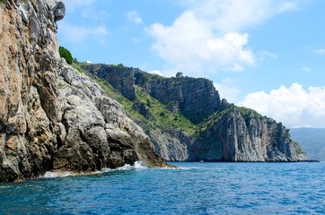 Watchtower on a marine cliff over sea in blue sky