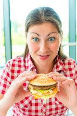 Portrait of hungry women and appetizing hamburger