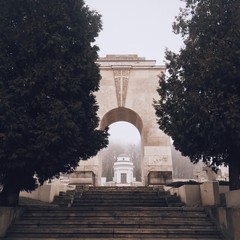 arch is hidden between the trees