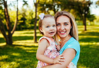 Fototapeta premium Happy mom and daughter smiling at nature.