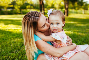 Happy mom and daughter smiling at nature.