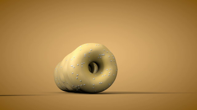 Bagel Roll into a Line. one by one sesame seed bagels roll into a row. brown gradient background with luma matte for isolation.
