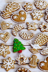 Christmas homemade gingerbread cookies on white wooden table