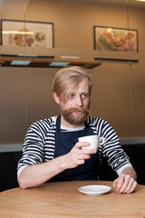 Handsome bearded man in cafe