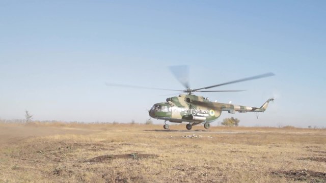Military helicopter takes off. The Mil Mi-8  is a Soviet-designed medium twin-turbine transport helicopter.