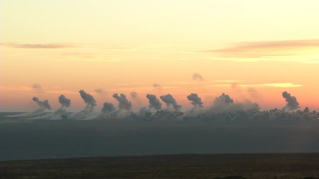 Battlefield in the fire: the bombardment of heavy artillery. Bombardment early in the morning. Many shells and thick smoke