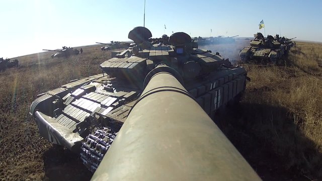 Tank with camera on the large-calibre cannon is rotating its gun turret.The machine also rotating gun turret