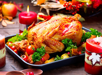 Roasted turkey garnished with potato, vegetables and cranberries. Thanksgiving or Christmas dinner