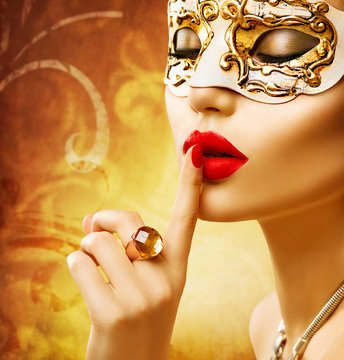 Beauty model woman wearing venetian masquerade carnival mask at party