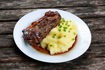 Rare beef steak with mashed potatoes