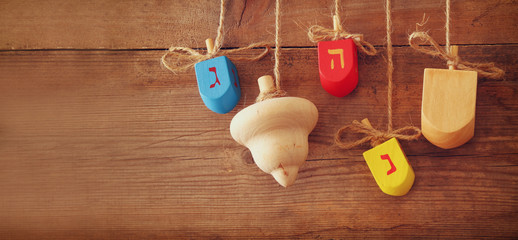 website banner image of of jewish holiday Hanukkah deridel (spining top).