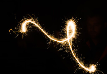 sparkler light trail in dark environment using slow shutter speed
