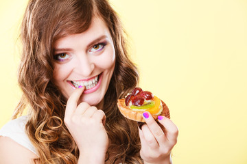 Closeup flirty woman eating fruit cake