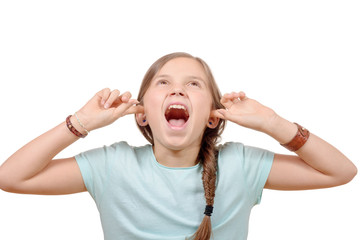 Stressed young girl covers ears with hands on white background