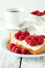 Fresh toast with raspberry on white wooden background