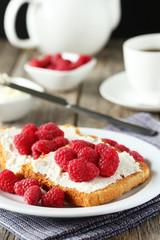 Fresh toast with raspberry on grey wooden background