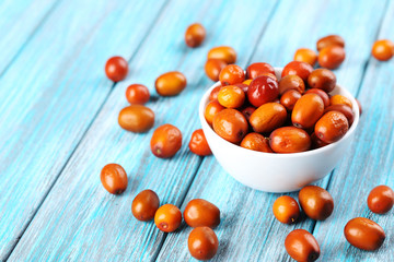 Ripe jujubes on blue wooden table, close up