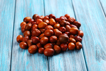 Ripe jujubes on blue wooden table, close up