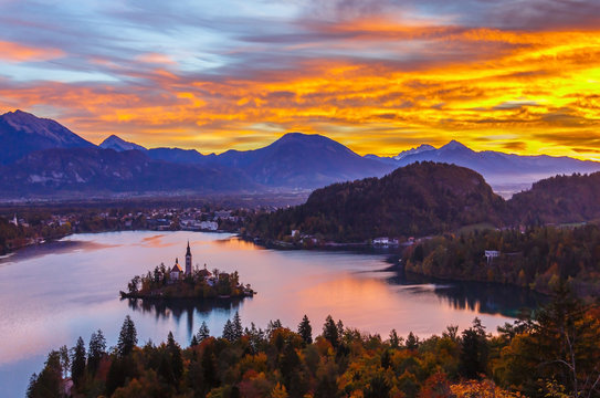Long exposure photograph of dark landscape of silhouette Bled island and European alps in the very early morning before sunrise with dramatic colorful sky, Bled, Slovenia, Europe