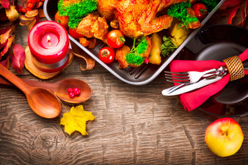 Thanksgiving dinner table served with turkey, decorated with bright autumn leaves
