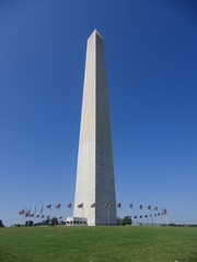 Obraz premium Washington Monument in Washington DC. View of the Washington Monument in Washington DC, with around a circle of American flags 