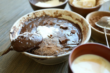 Preparing dough for chocolate pie on table close up