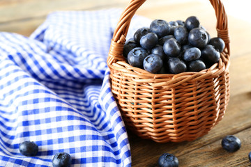 Tasty ripe blueberries in basket on table close up