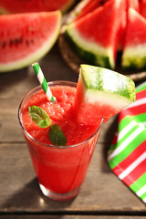 Glass of watermelon juice on wooden table, closeup