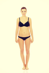 Fototapeta premium Happy woman standing in bikini.