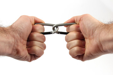 two clasped hands holding a climbing carabiners