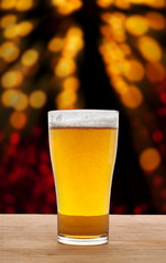 Glass of beer on wooden in bokeh