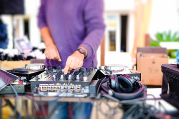 Closeup of dj's hands mixing audio tracks with professional  equipment
