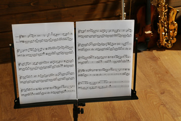 Fototapeta na wymiar Note holder against musical instruments on wooden background
