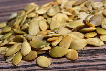 Pumpkin seeds on wooden background