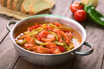 Hungarian traditional dish called Lecso, a vegetarian stew made of onion, pepper and tomato, seasoned with salt and pepper (Selective Focus, Focus in the middle of the dish)