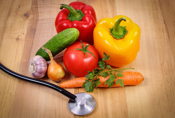 Fresh vegetables and stethoscope on wooden surface, healthy lifestyle and nutrition