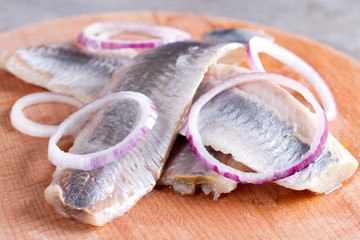 Pieces of herring fillet on a cutting board