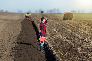 Farmer with tractors on field - obrazy, fototapety, plakaty