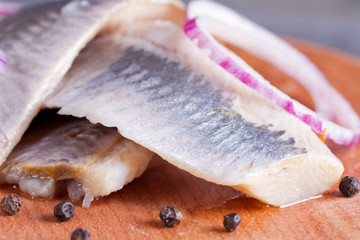 Pieces of herring fillet on a cutting board